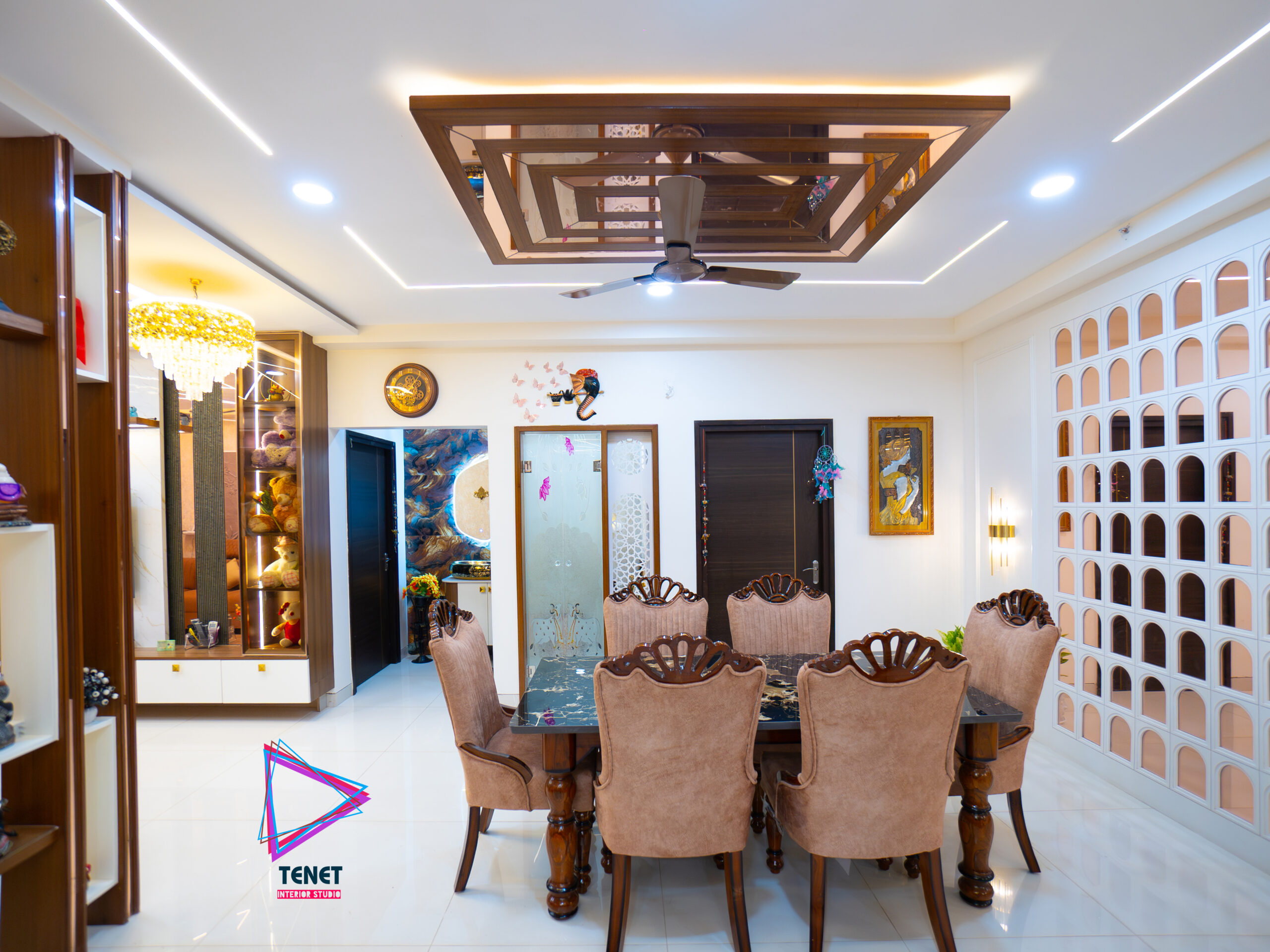 Luxury living room showcasing marble flooring, wooden furniture, linen sofa, textured wall panels, and premium finishes designed by Interior Designers in Hyderabad.
